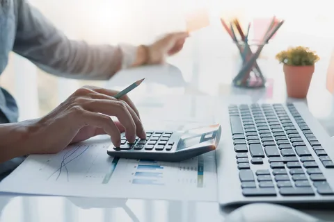 Person using a calculator, symbolizing the precise and tailored approach to Amazon Account Reinstatement