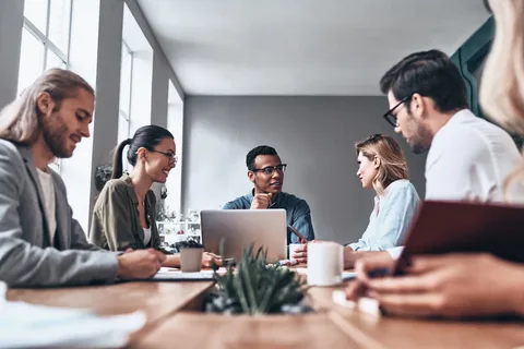 Employees discussing plans for setting up Facebook Marketplace for Business